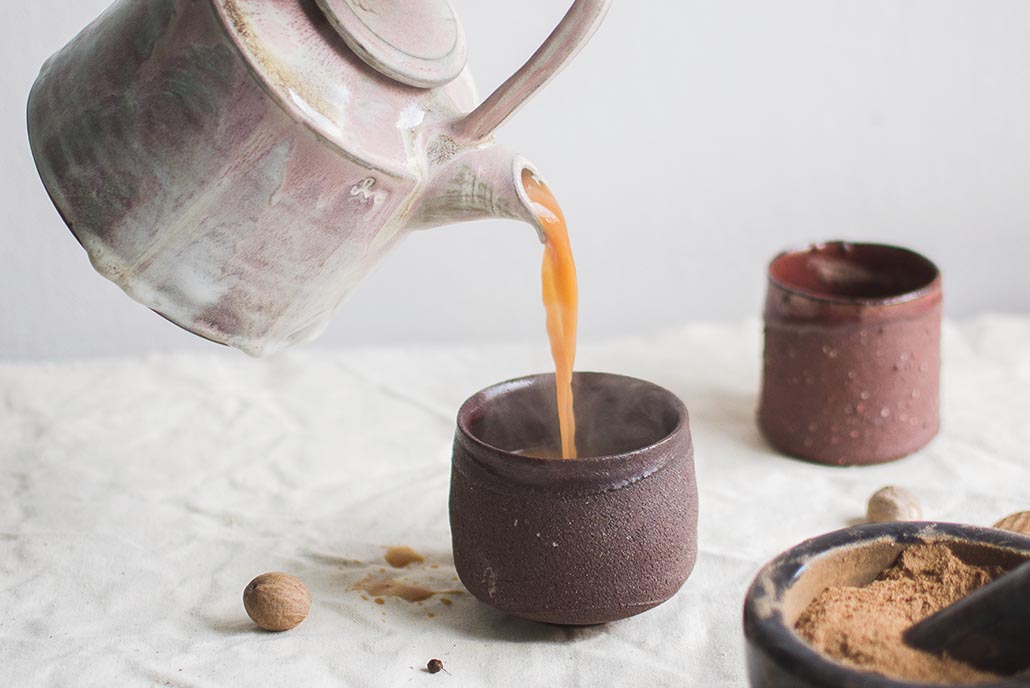 pouring tea into cup to relax and de-stress